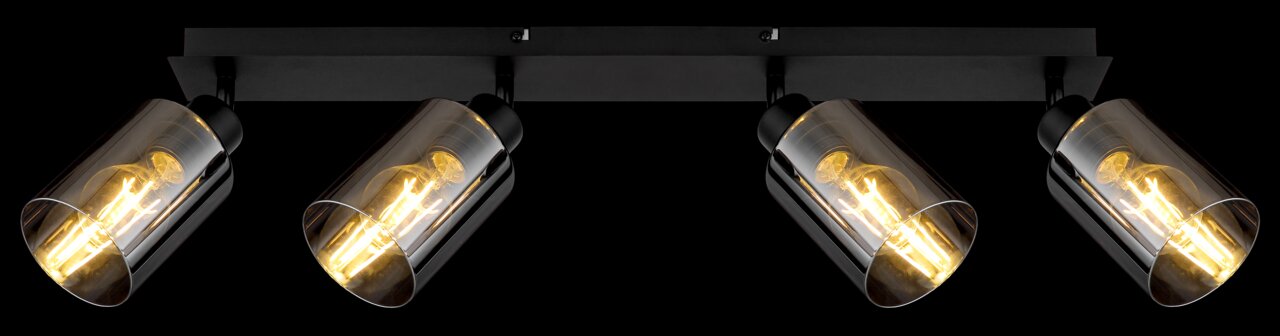 Vierflammiger Strahler aus schwarzem Metall mit mattem Finish, seitliche Perspektive, leuchtende Glühbirnen sichtbar.