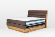 Boxspringbett mit sichtbarem Federkern, seitliche Perspektive