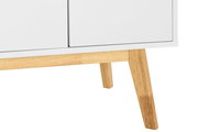 Nahaufnahme eines weißen Sideboards mit Holzbeinen, perspektivisch von der Seite aufgenommen.