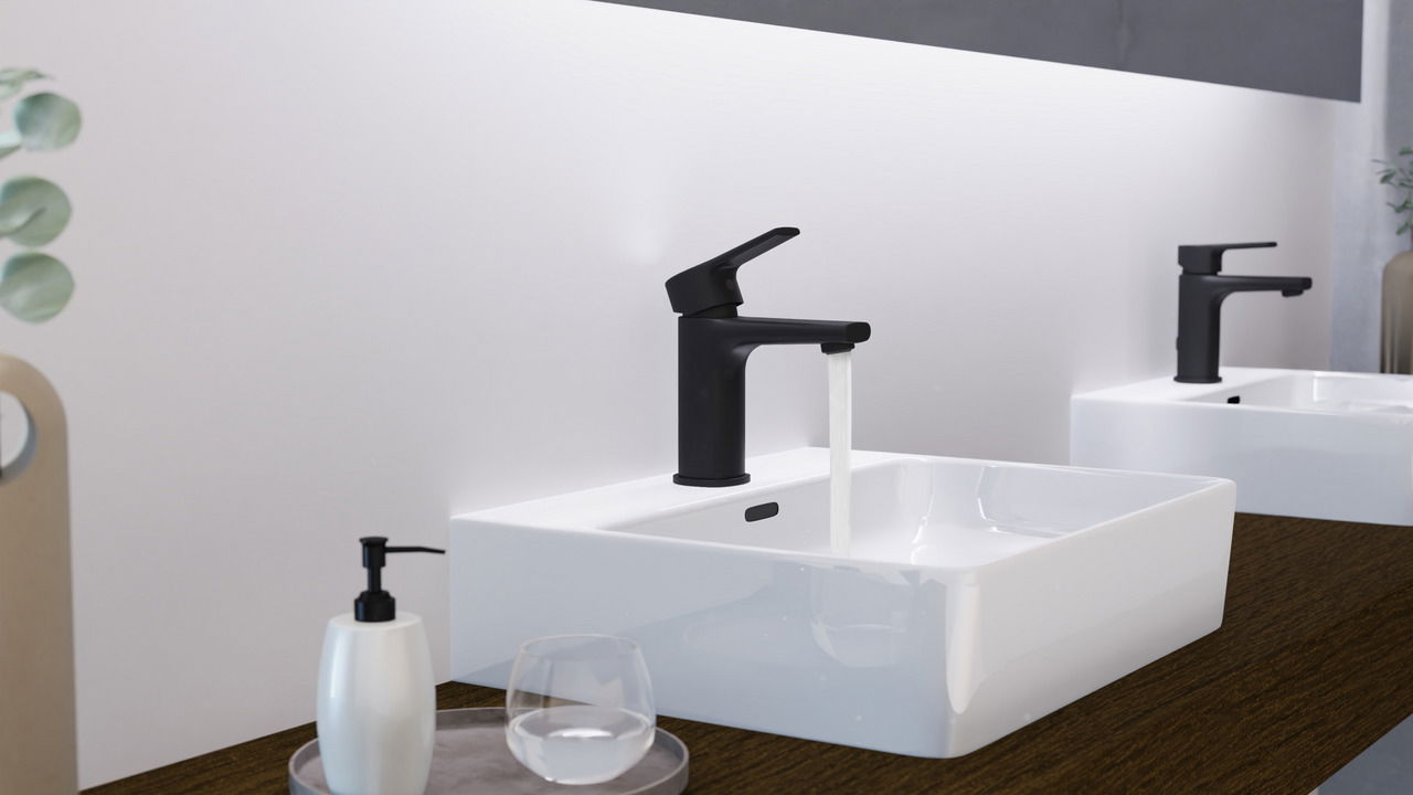 Moderne schwarze Waschtischarmatur mit fließendem Wasser, seitliche Perspektive