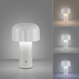 Moderne Akku-Tischleuchte AGNES mit weißem, zylindrischem Sockel und rundem, opalem Schirm, frontal abgebildet.