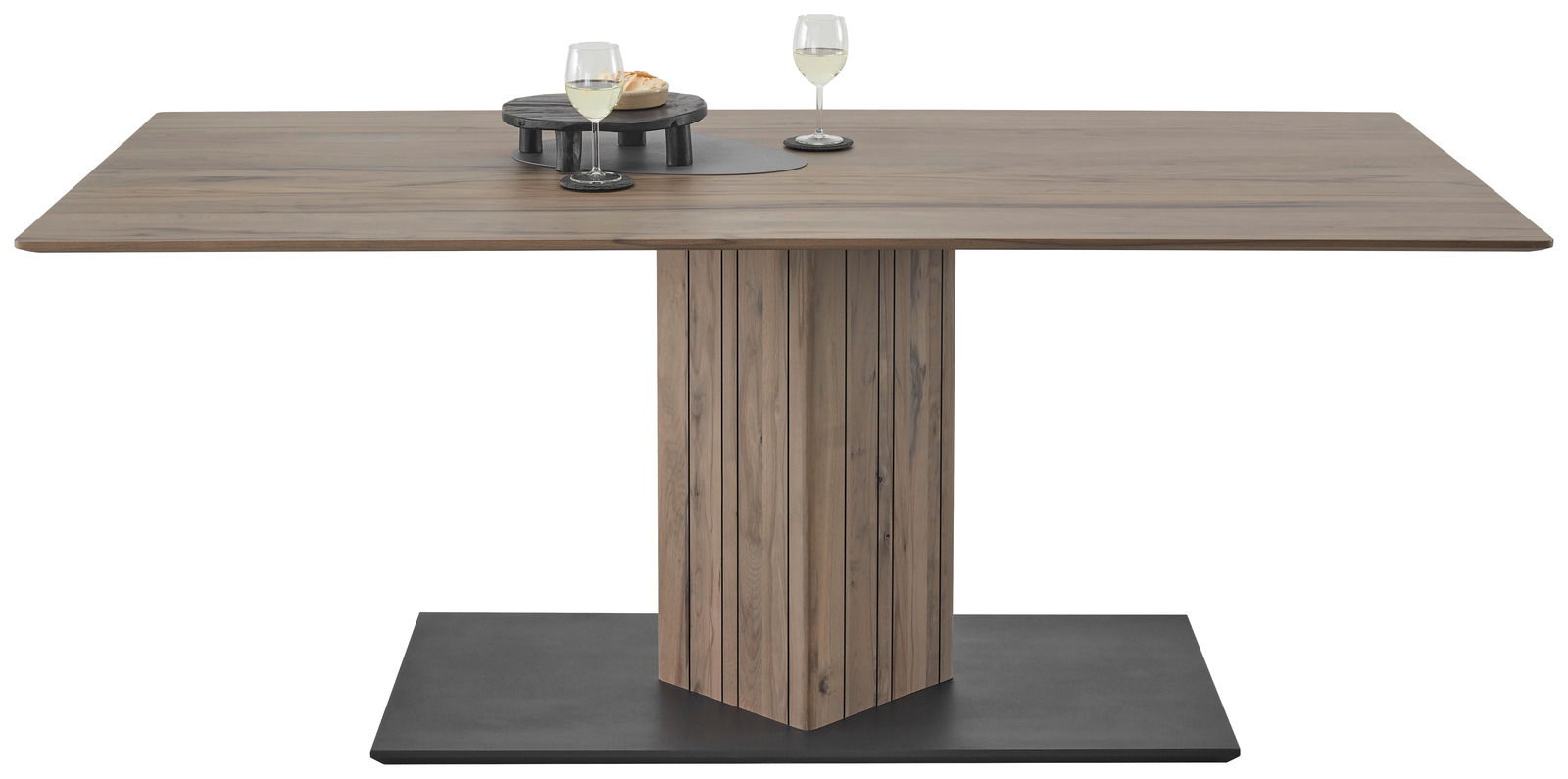 Moderner Esstisch aus Holz mit zentralem Standfuß, rechteckiger Tischplatte und zwei Gläsern auf der Oberfläche, frontal betrachtet.