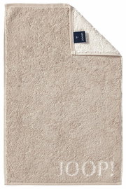Beiges Gästetuch mit eingewebtem 'JOOP!' Logo, von oben fotografiert, mit umgeschlagener Ecke, die das Etikett zeigt.