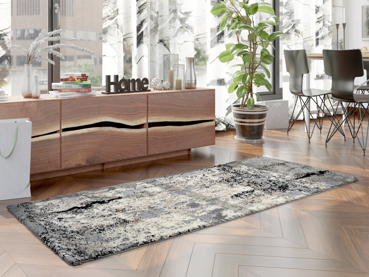 Moderner Designer Teppich in Grau- und Beigetönen auf einem Holzboden, umgeben von stilvollen Möbeln und Pflanzen, aus seitlicher Perspektive fotografiert.
