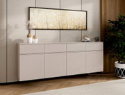 Modernes, schwebendes Sideboard in Greige/Taupe mit grifflosen Fronten vor Wandpaneelen, darüber ein breites Wandbild; Perspektive: Frontansicht leicht schräg von links.