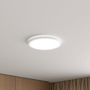 Runde, flache LED-Deckenleuchte in Weiß an der Zimmerdecke, leuchtend – Ansicht von unten in leichter Untersicht