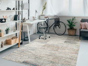 Moderner Frisé-Teppich in einem stilvollen, hellen Arbeitszimmer mit Schreibtisch, Fahrrad und Pflanzen, aus der Vogelperspektive betrachtet.