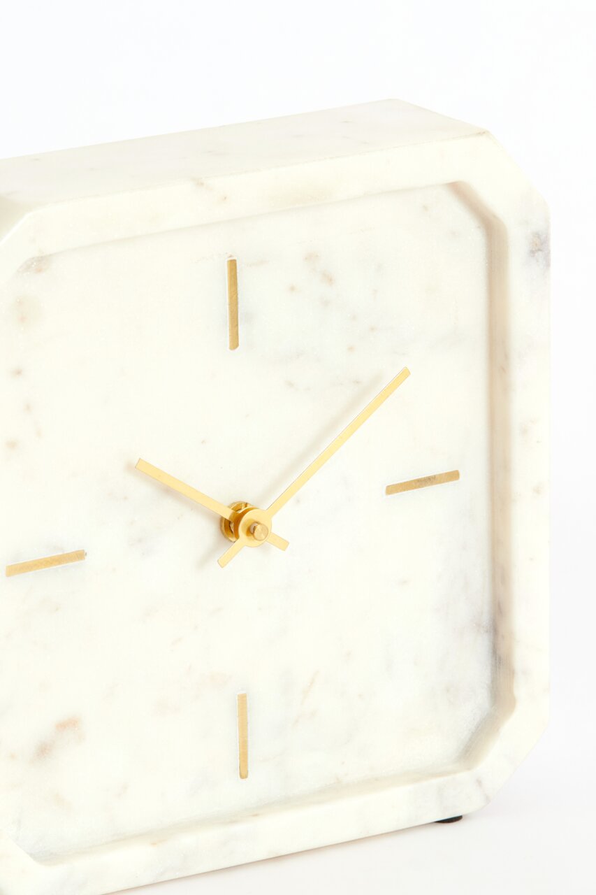 Elegante Tischuhr aus weißem Marmor mit goldenen Zeigern und minimalistischen Markierungen, seitliche Perspektive