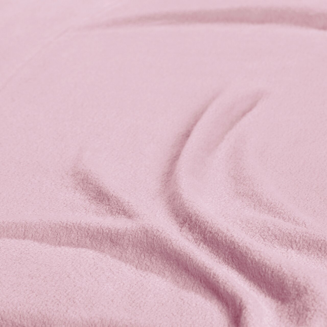 Nahaufnahme eines rosa Spannbetttuchs mit weicher Textur und Falten.
