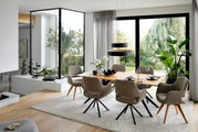 Moderne eethoek met een grote houten tafel en comfortabele stoelen met armleuningen, omgeven door grote ramen met uitzicht op het groen. Perspectief: zijaanzicht.