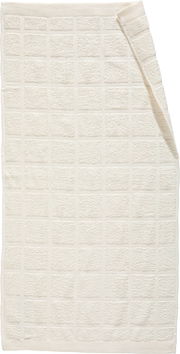 Frottierset in cremeweißer Farbe mit quadratischem Muster, aus der Vogelperspektive fotografiert.