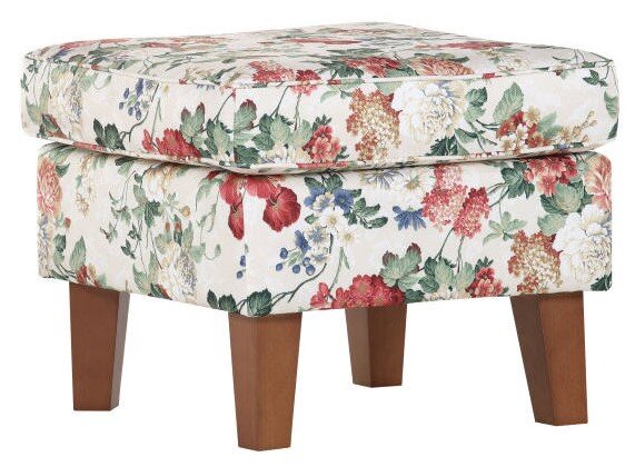 Hocker mit floralem Muster und Holzbeinen, seitliche Perspektive