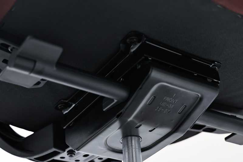 Unterseite eines Drehstuhls mit Fokus auf die Mechanik und Gasfeder, von unten fotografiert.