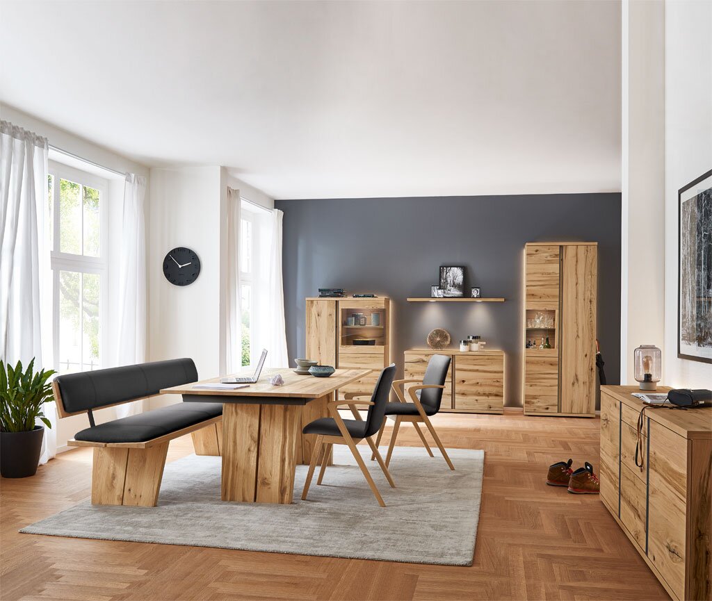 Moderne Wohnzimmermöbel in heller Holzoptik mit Sideboard, Highboard und Vitrine, seitliche Perspektive.