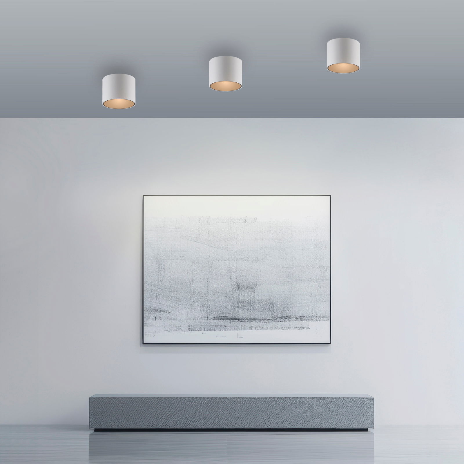 Drei zylindrische LED-Deckenleuchten in moderner Raumgestaltung, von unten betrachtet.