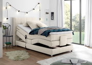 Boxspringbett in modernem Schlafzimmer, seitliche Perspektive, mit verstellbarer Matratze und gemütlicher Dekoration.