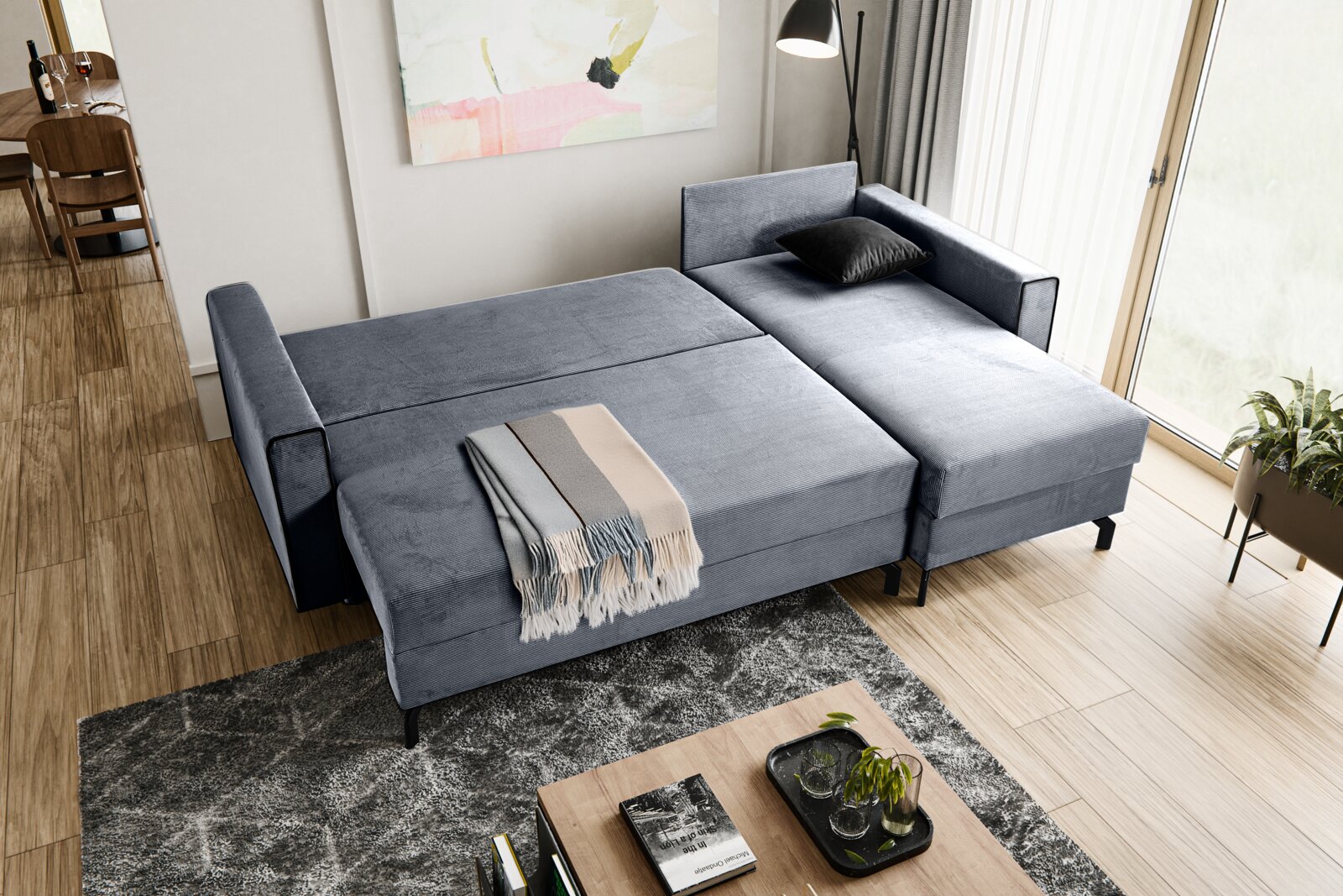 Schlafsofa in L-Form mit rechter Ausrichtung, in einem modernen Wohnzimmer mit Holzboden und großen Fenstern, aus der Vogelperspektive fotografiert.