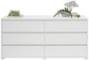 Weißes XL-Sideboard mit sechs Schubladen, dekoriert mit Büchern und Pflanzen, Frontalansicht.