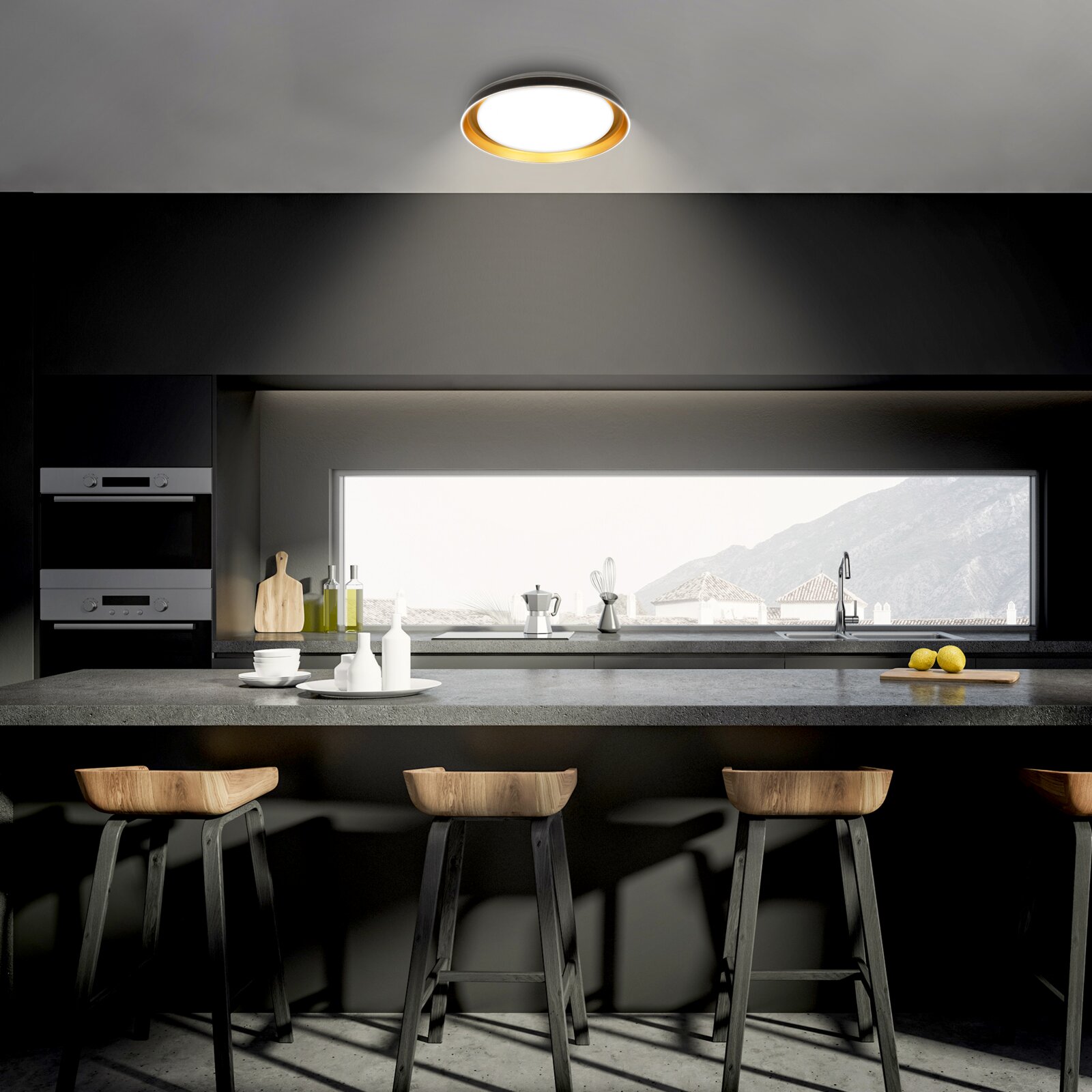 Ronde plafondlamp met goudkleurige binnenring, van schuin onderen gezien in een moderne zwarte keuken