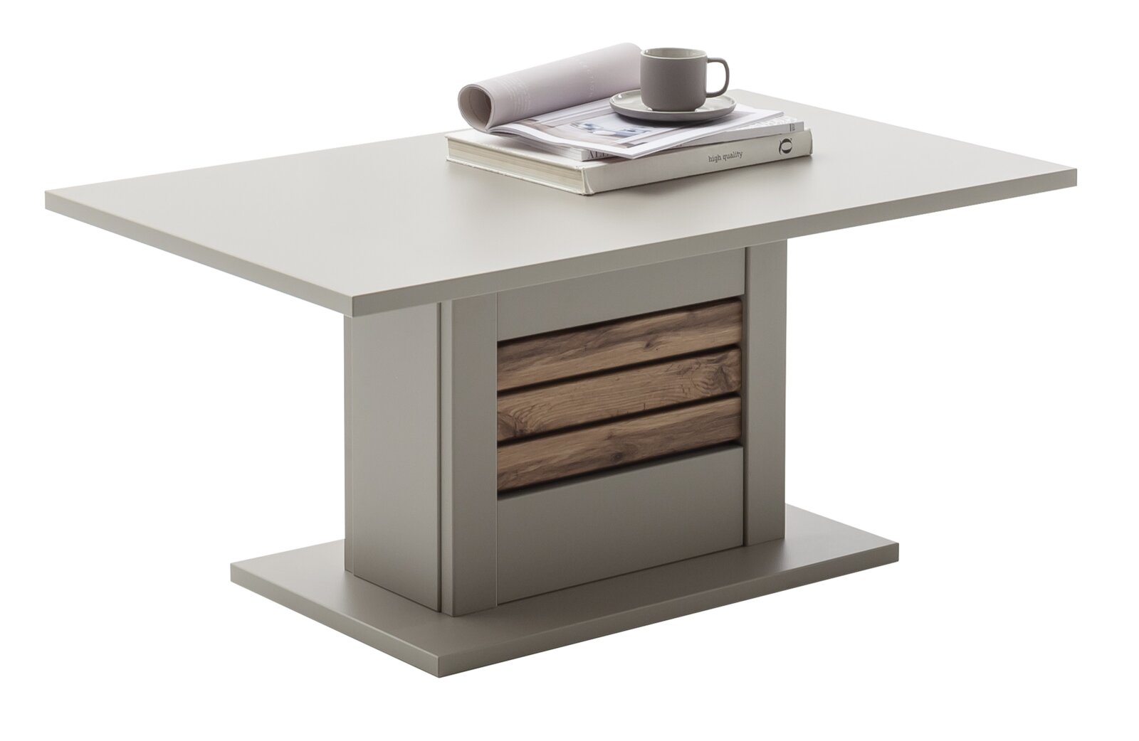 Quadratischer Esstisch in Grau mit zentralem Sockel und Holz-Lamellen-Akzent, auf der Tischplatte liegen Buch, Zeitschrift und Tasse; Ansicht schräg von vorne.