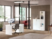 Moderner Büroraum mit weißem Schreibtisch, Bürostuhl und niedrigem Aktenschrank, seitliche Perspektive