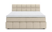 Frontale Ansicht eines beigen Boxspringbetts mit gestepptem Kopfteil und weißer Matratze.