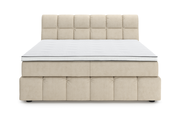 Frontale Ansicht eines beigen Boxspringbetts mit gestepptem Kopfteil und weißer Matratze.