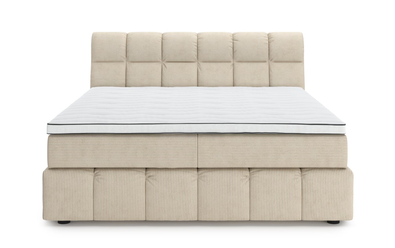 Vooraanzicht van een beige boxspring met een doorgestikt hoofdeinde en een wit matras.