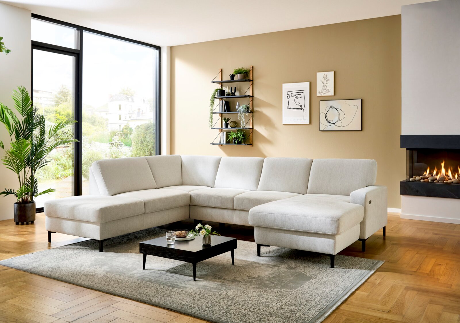 Helles L-förmiges Ecksofa mit beigem Stoffbezug und zwei Chaiselongues in modernem Wohnzimmer, perspektivisch in frontaler 3/4-Ansicht von links aufgenommen