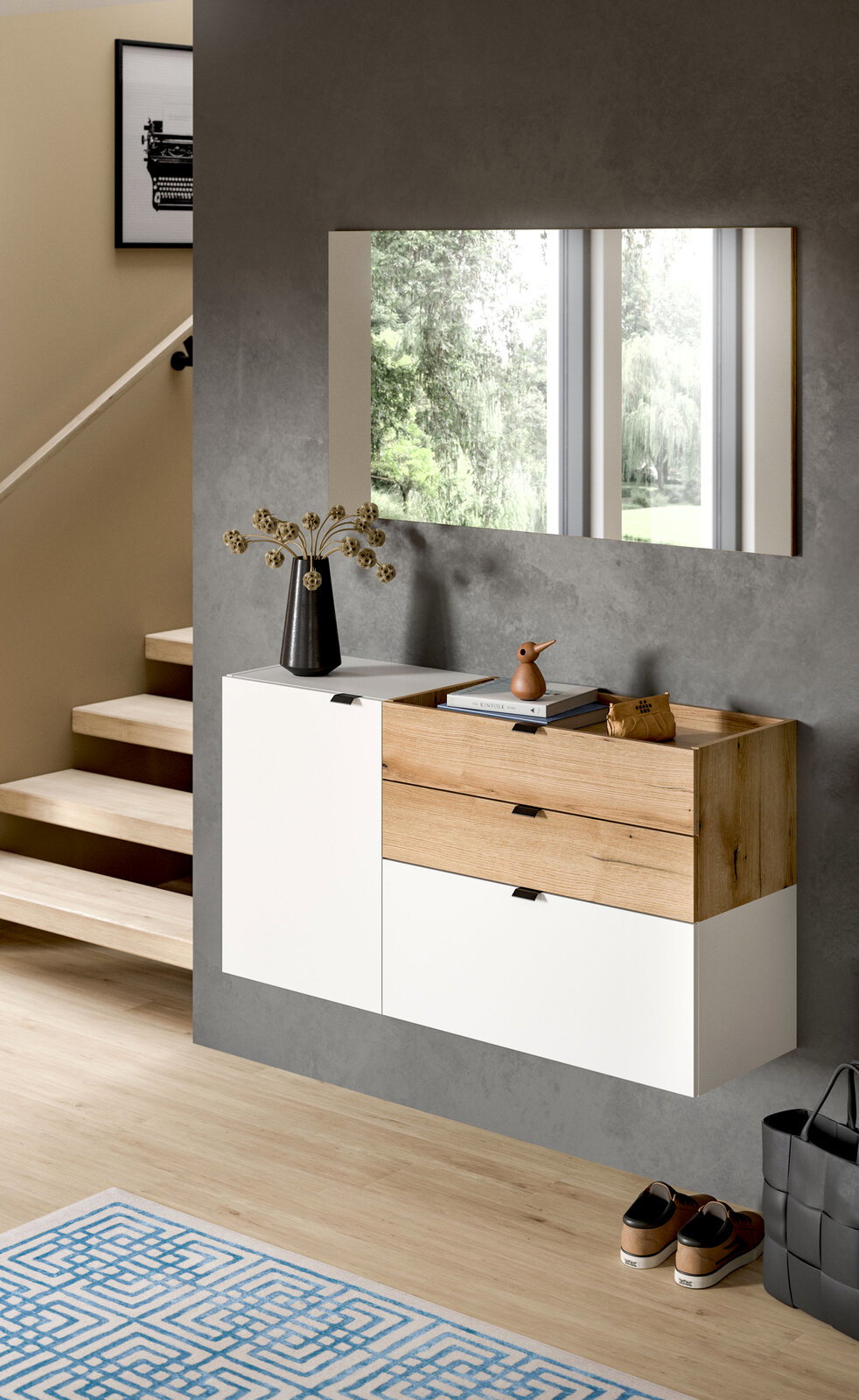 Modernes, wandhängendes Sideboard im Flur mit weißer Front und Holzschubladen unter einem rechteckigen Wandspiegel, fotografiert in frontaler Perspektive mit leichtem Blick von links.