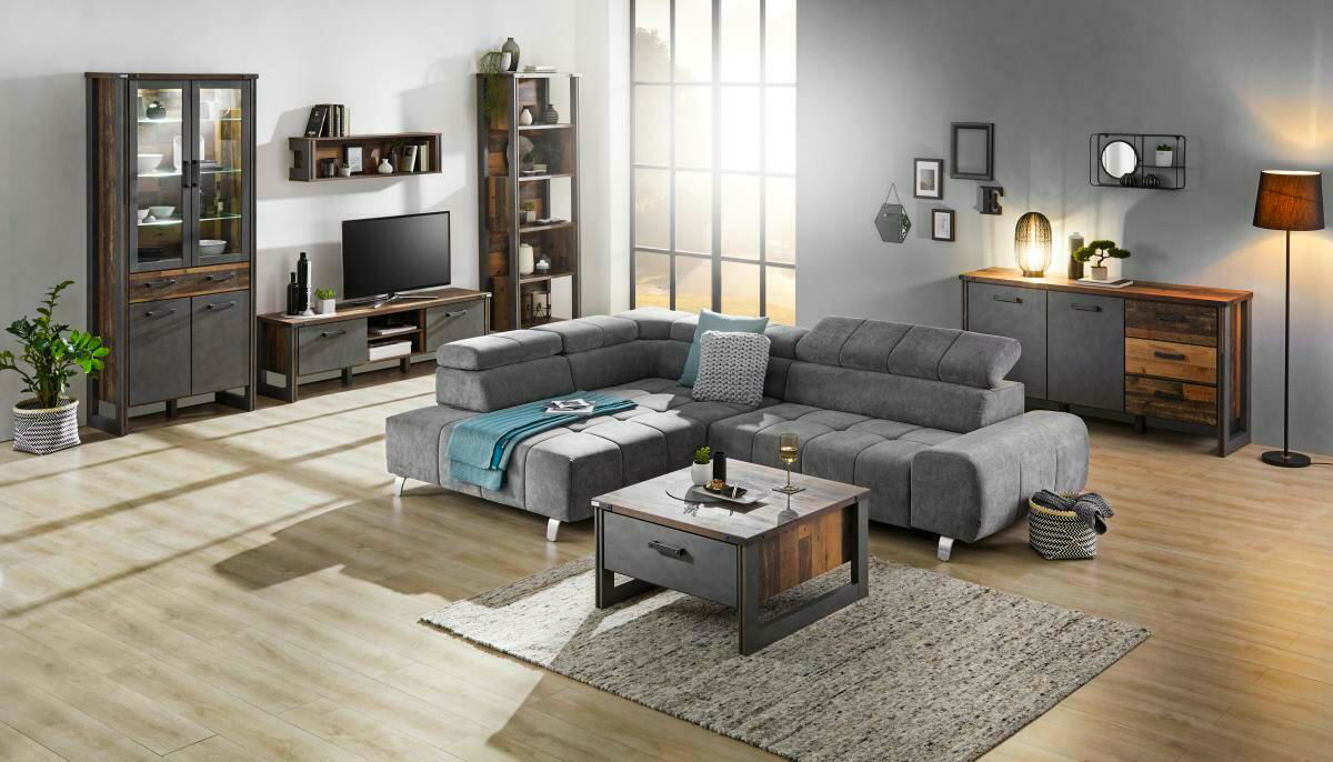 Graues Ecksofa TAIFUN mit Ottomane links in modernem Wohnzimmer, seitliche Perspektive