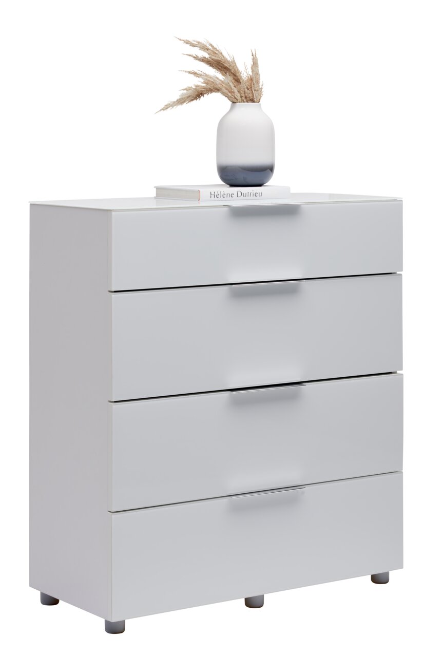 Weiße Schubkastenkommode mit vier Schubladen, dekoriert mit einer Vase und einem Buch, seitliche Perspektive