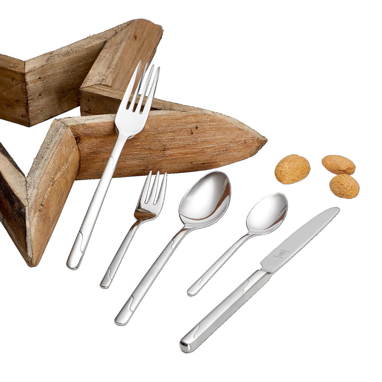 Elegantes Besteckset Viva 60-tlg. aus Edelstahl, bestehend aus Messer, Gabel, Löffel und Teelöffel, auf schwarzem Hintergrund mit Holzstern und Mandeln, aus der Vogelperspektive.