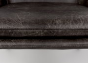 Nahaufnahme eines Sesselsitzes aus dunkelgrauem Leder mit sichtbaren Nähten, von vorne betrachtet.