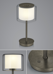 LED-Tischleuchte KLARA mit zylindrischem, transparentem Schirm und metallischem Standfuß, seitliche und obere Perspektive