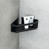 Schwarze Eckablage Meleto an einer grauen Wand montiert, mit zwei Tuben darauf, seitliche Perspektive.