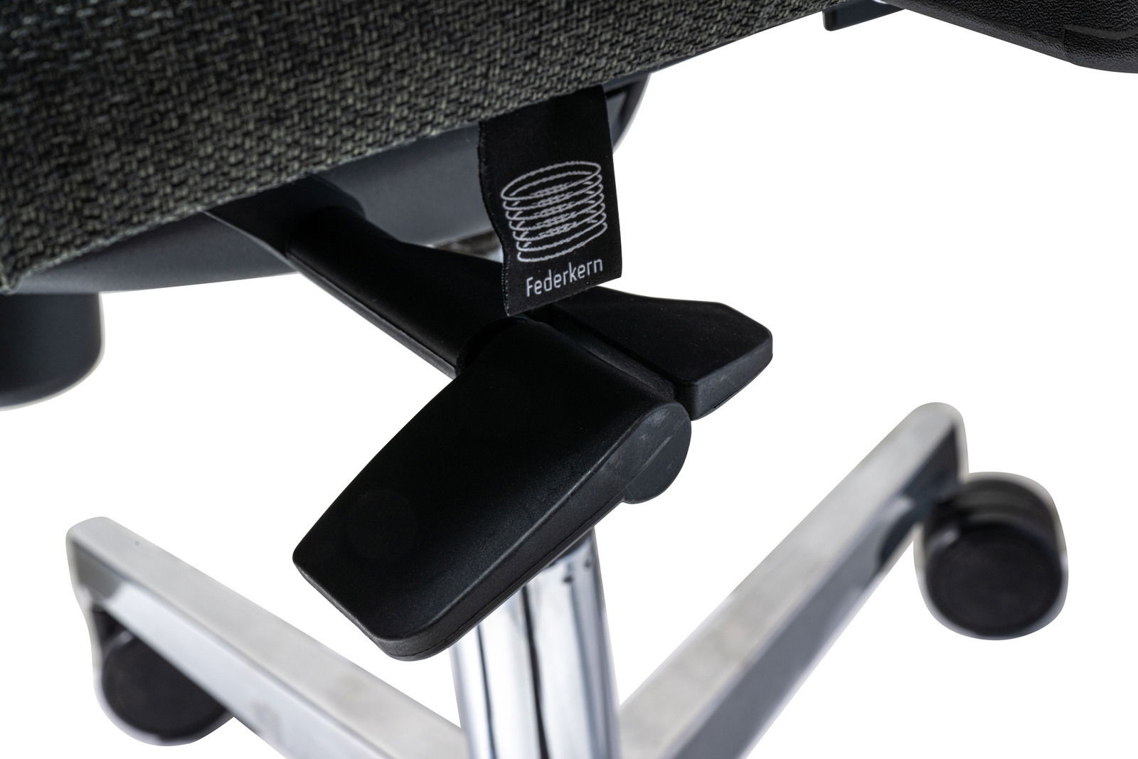 Nahaufnahme eines Drehstuhls mit Federkern, Fokus auf die Unterseite und die Rollen.