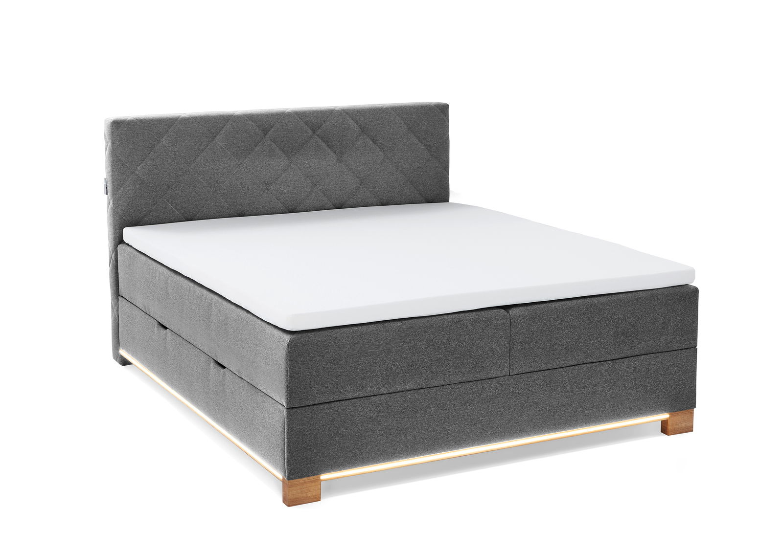 Graues Boxspringbett mit gestepptem Kopfteil, seitliche Perspektive