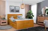 Gemütliches Boxspringbett 140 in einem modernen Schlafzimmer, frontal fotografiert, mit senfgelbem Bezug, dekorativen Kissen und stilvoller Einrichtung.