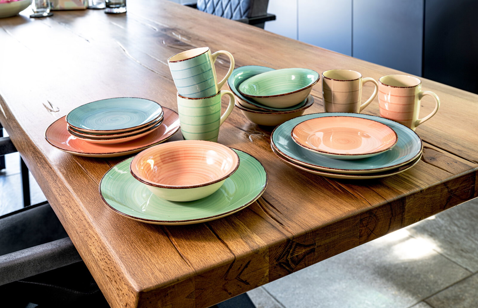 Kombiservice 16-tlg. in Pastellfarben auf einem Holztisch, seitliche Perspektive