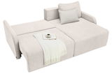 Beige Ecksofa mit ausziehbarer Liegefläche, dekoriert mit einem Kissen, einer Decke, einem Buch und einer Tasse, aus der Vogelperspektive.