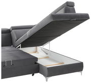 Graue Rundecke mit hochgeklappter Sitzfläche, die den Stauraum darunter zeigt. Perspektive von der Seite.