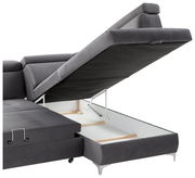 Graue Rundecke mit hochgeklappter Sitzfläche, die den Stauraum darunter zeigt. Perspektive von der Seite.