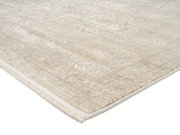 Beiger Designer Teppich mit subtilen Mustern, perspektivisch von der Seite fotografiert.