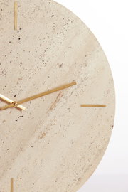 Nahaufnahme einer eleganten Uhr mit einem Zifferblatt aus hellem Naturstein und goldenen Zeigern, frontal betrachtet.