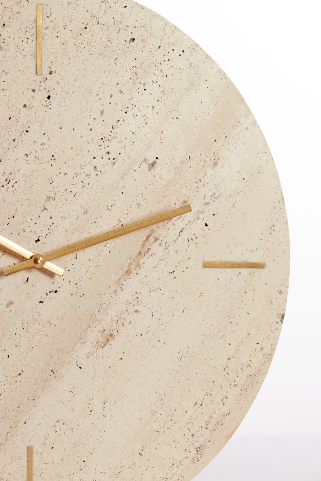 Close-up van een elegant horloge met een wijzerplaat van lichte natuursteen en gouden wijzers, gezien van voren.
