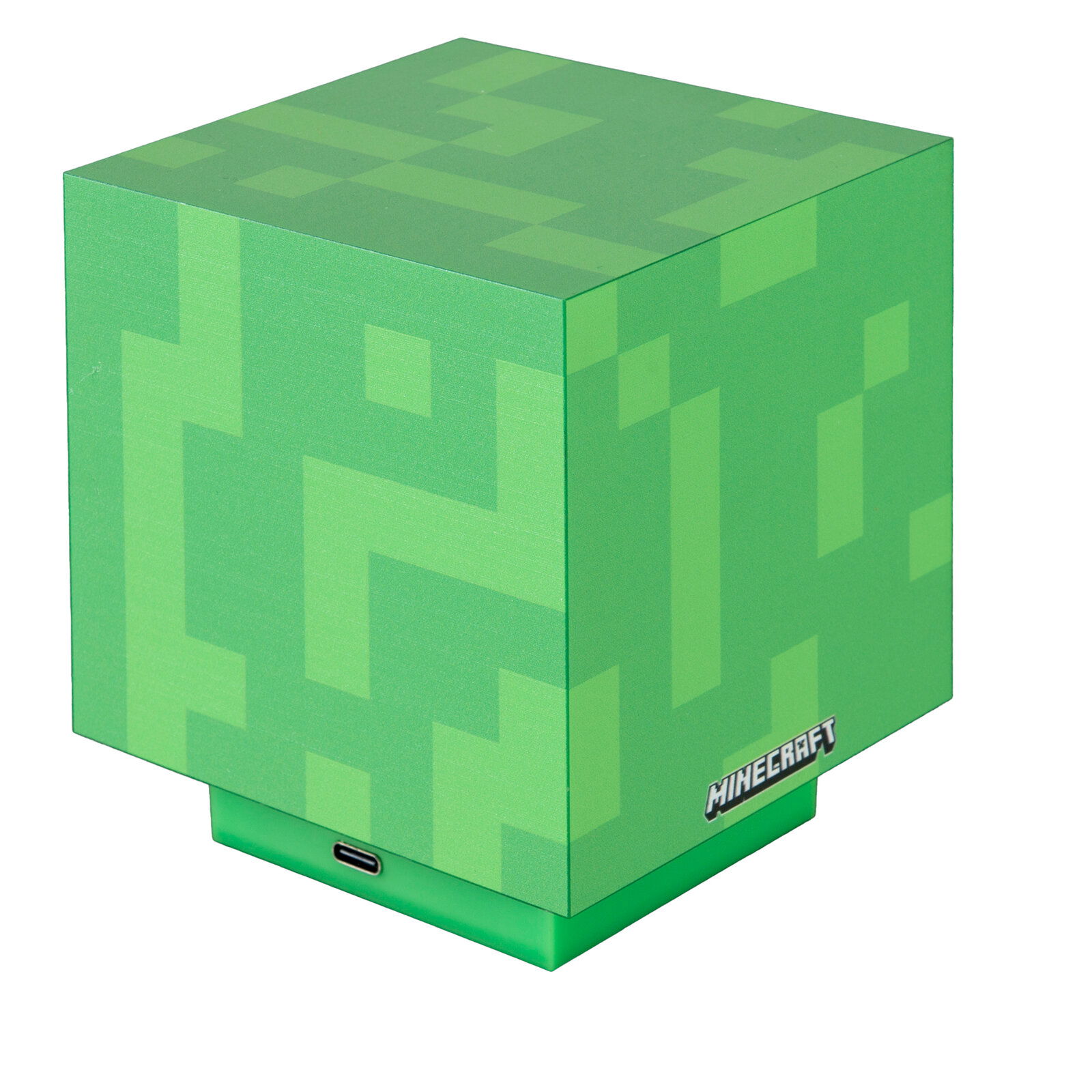 Grünes, würfelförmiges Minecraft-Produkt mit pixeligem Muster und USB-C-Anschluss am Sockel, schräg von vorne oben fotografiert
