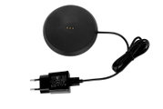 Zwarte oplader met ronde voet en kabel, gezien van bovenaf