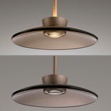 Moderne Pendelleuchte PURE Moon in seitlicher Perspektive mit elegantem, flachem Schirm und warmem Licht.