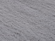 Nahaufnahme eines grauen Fellteppichs mit weicher Textur